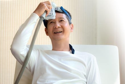 A healthy middle-aged man who appears to be enjoying his CPAP.