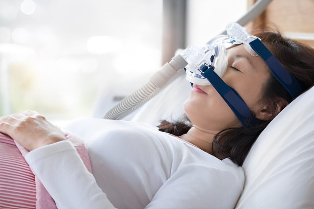 A woman using a CPAP machine is having a quality sleep.