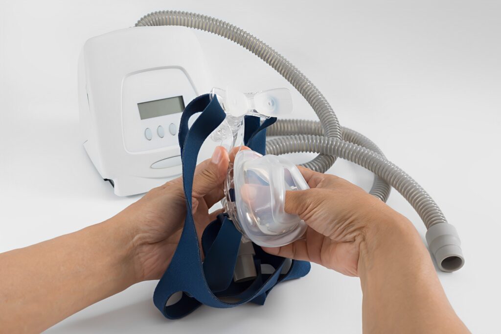 A picture of man replacing his CPAP headgear