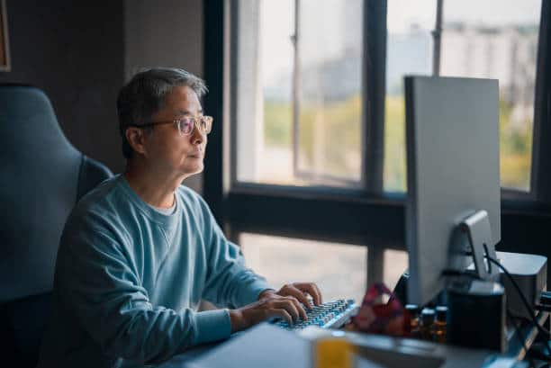 A picture of a senior man using his desktop