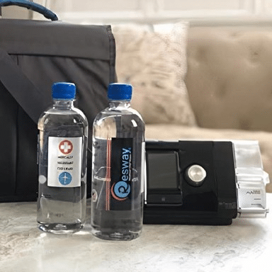 A picture of a Resway distilled water and a CPAP machine.