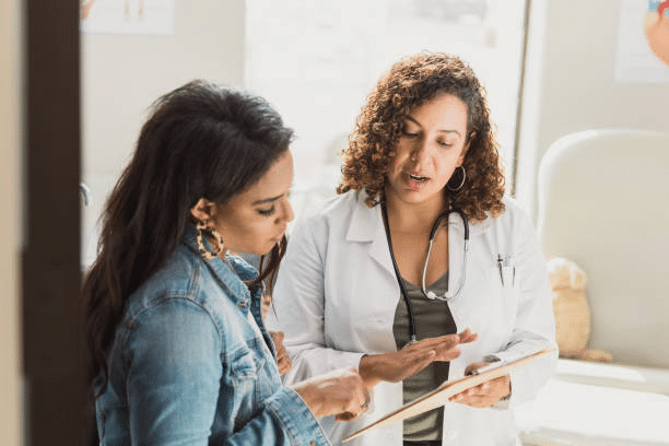 A photo of a doctor explaining to her patient