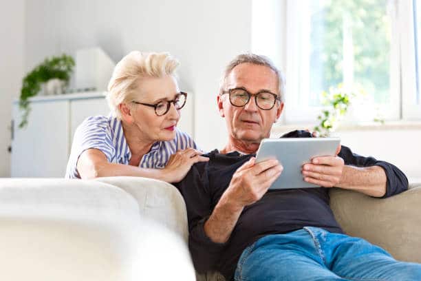 Middle-aged couple using a tablet device