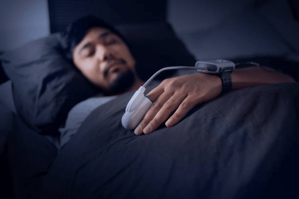 A man sleeping while conducting home sleep test 